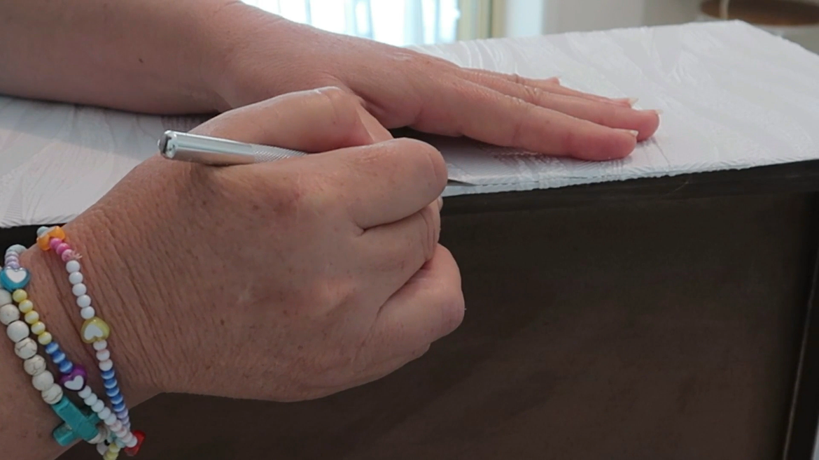 Taking off excess paper.