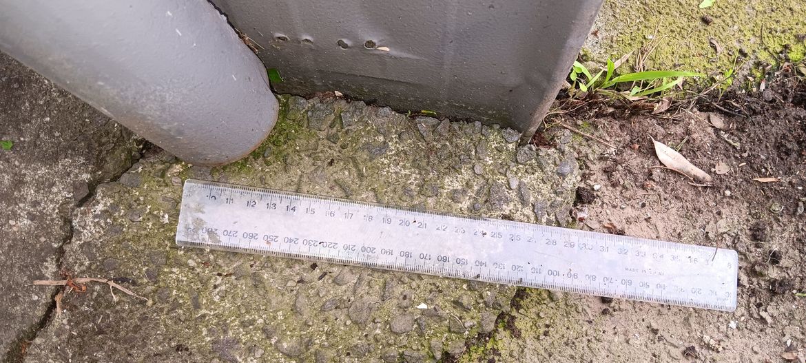 The replace shoe should exit past the corner of the garage, in the direction of the ruler.