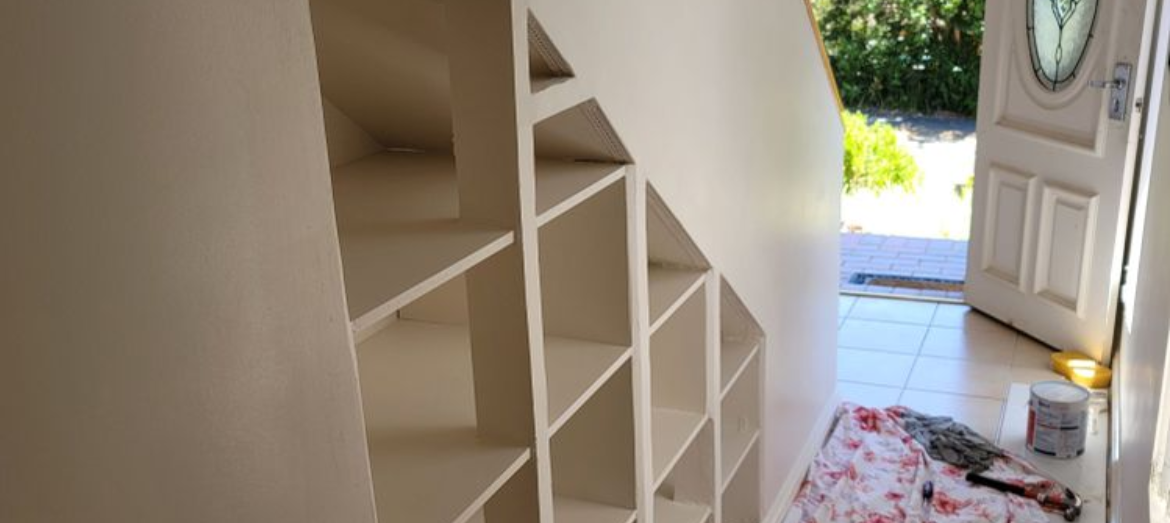 Shoe shelves built into staircase.png