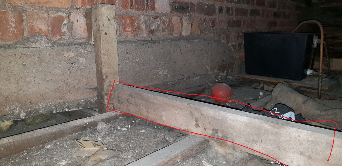 beam goes into joist at end of building which is cemented into place