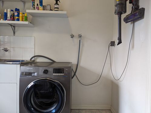 Bench spanning from sink, across washing machine and void