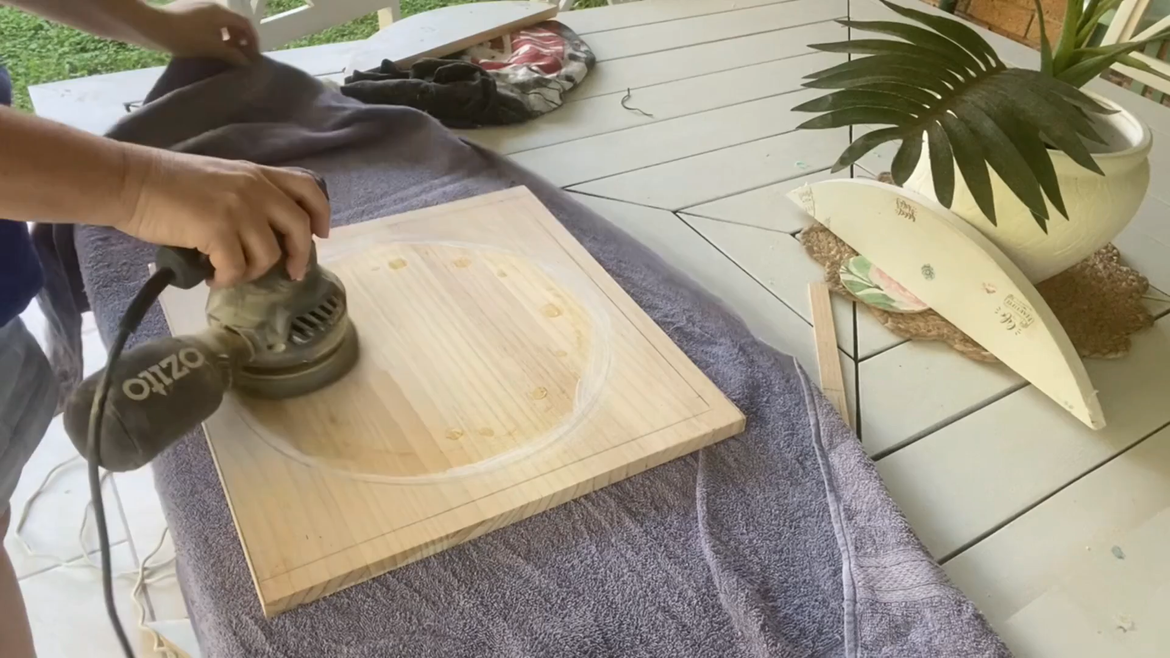 Sanding off the previous paint and glue marks.