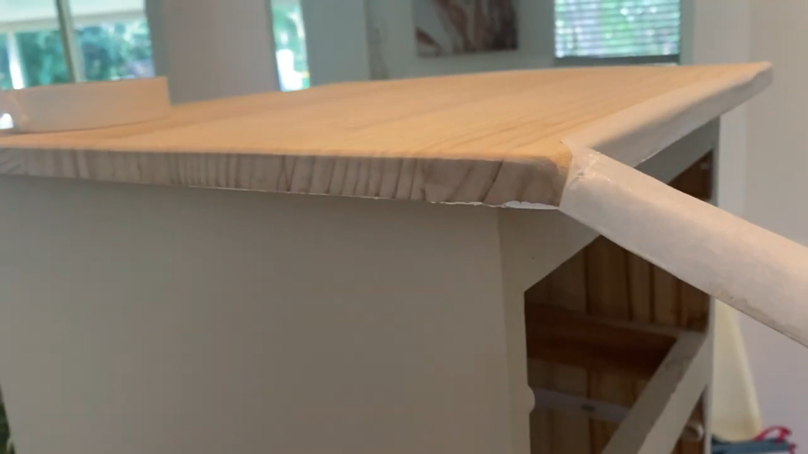 Peeling off the protective masking tape off the top.