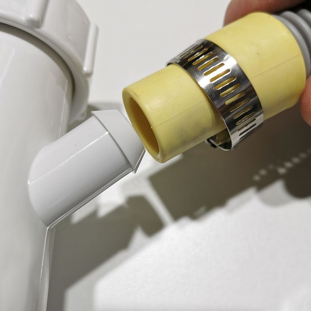 5.2 Pushing waste hose onto spigot.jpg