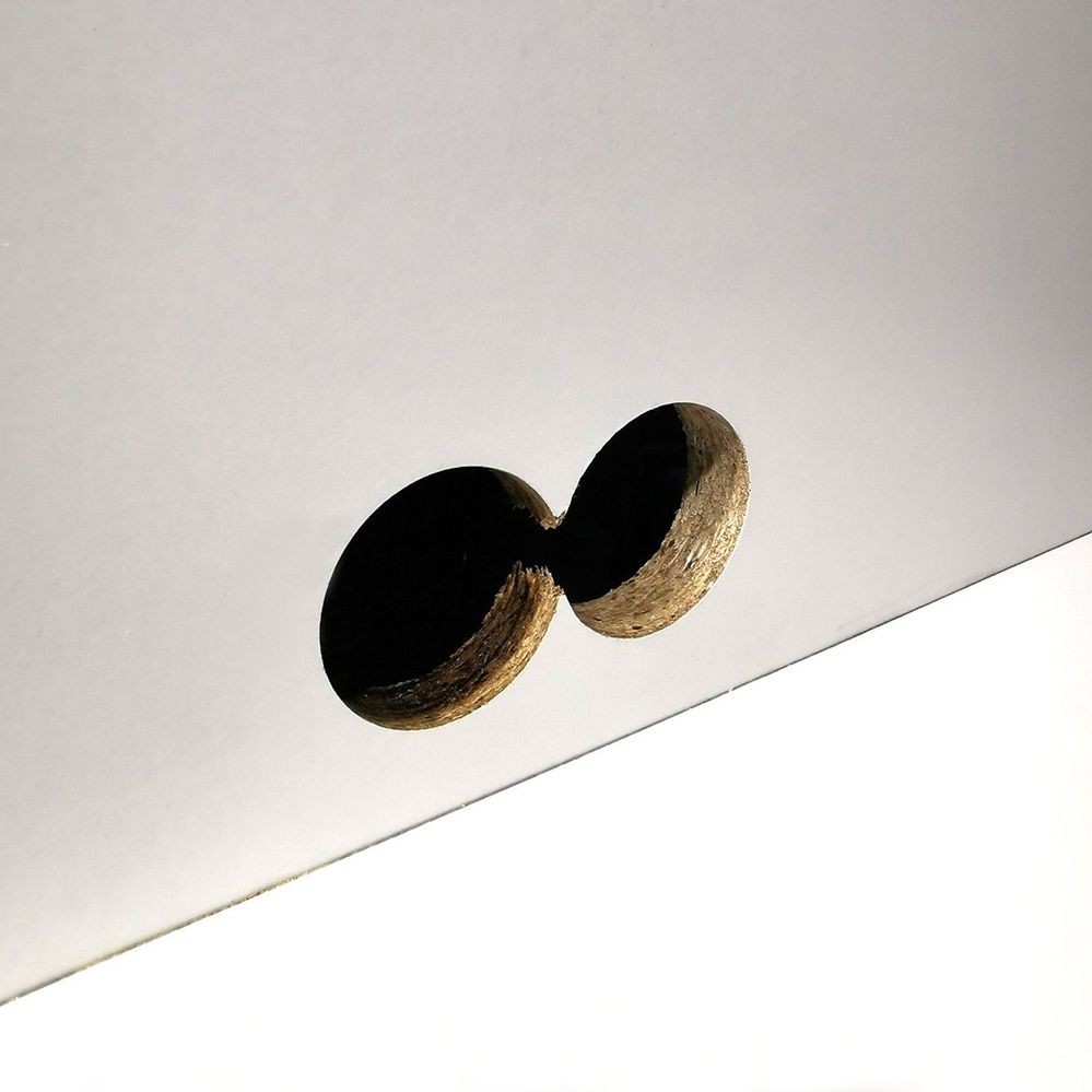 1.3 Holes drilled in cabinet panel.jpg