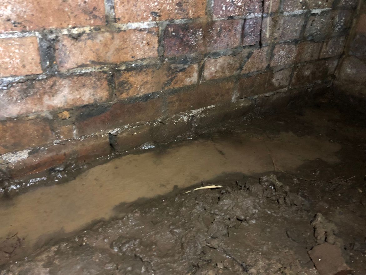 Water seeping through wall under house